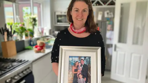 Anna with a photograph of her family