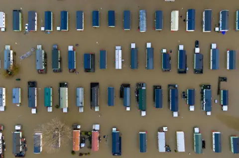 Jordan Pettitt/PA Media Flooded caravans astatine  Billing Aquadrome Holiday Park adjacent   Northampton, Northamptonshire, seen from above