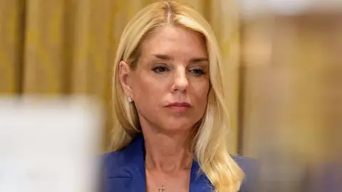 US Attorney General Pam Bondi pictured wearing a blue suit and looking down during a hearing