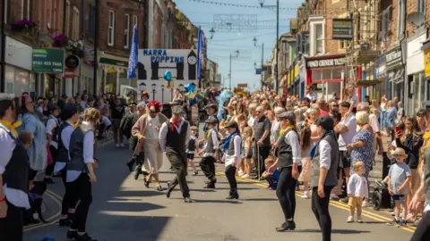 Maryport Carnival Committee One of the acts performing on Senhouse Street in Maryport for a past carnival