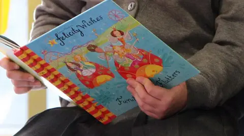 A child reading a book called Felicity Wishes.
