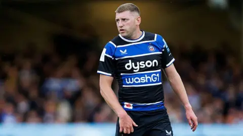 Finn Russell standing on the pitch during a match