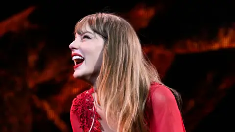 Getty Images Taylor Swift smiles at the Cardiff crowd