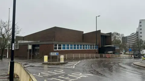 Alice Cunningham/BBC A wider view of the former crown court in Ipswich. A roundabout can be seen in front of the building. Other large office block buildings can be seen in the distance on the right. 