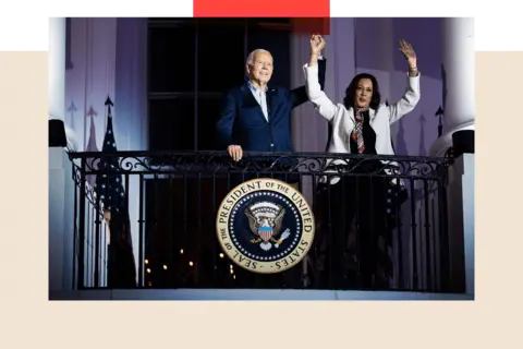 Getty Images Kamala Harris and Joe Biden on the White House balcony during 4th July celebrations. She is wearing a white jacket and him an open necked shirt and blue suit. Both her hands are raised and President Biden is holding one of them