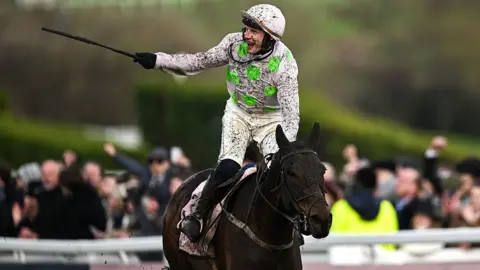Jockey Paul Townend celebrates winning the Cheltenham Gold Cup on Gaelic Warrior
