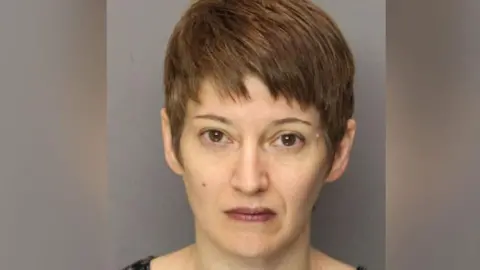 Essex County Correctional Facility Anna Stubblefield successful  an representation  which appears to beryllium  a mug shot. She is looking straight  astatine  the camera and has abbreviated  brownish  hair. 