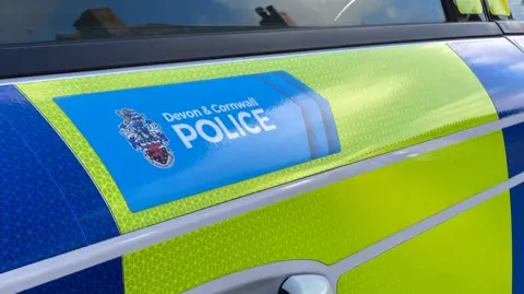 The door of a yellow and blue police vehicle.