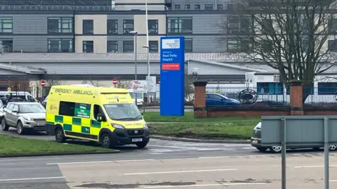 Royal Derby Hospital with an ambulance at the front of the image.