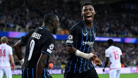 Raphael Onyedika of Club Brugge celebrates 2-0 with Carlos Forbs