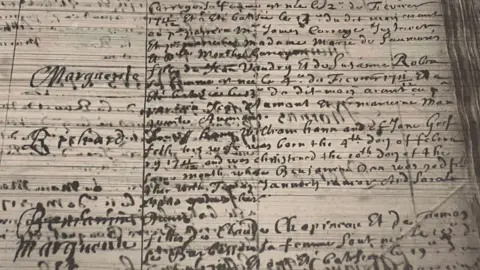 Priaulx Library A hard to read baptism record, written in cursive handwriting on parchmant.