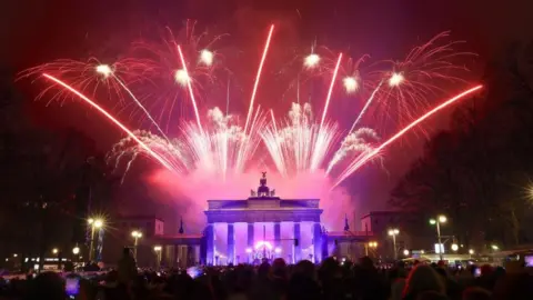 EPA Fireworks are seen over the Quadriga statue of the Brandenburg Gate during New Year's Eve celebrations in Berlin, Germany.