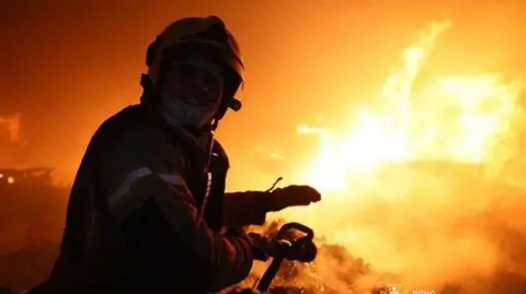 DSNS Ukraine A firefighter tackles a fire in Dnipro