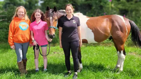 My Lovely Horse Rescue Woody posed for a photo with Kelly, Orianna and Kelsie