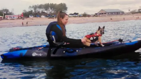 Teresa Hall Morgan and her small dog Peaches on a kayak