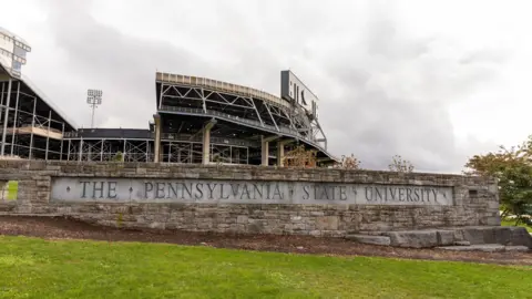 Getty Images A sign saying The Pennsylvania State Univeristy in a cement wall outside the university's athletic stadium 