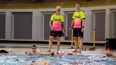 Jacqui and Oliver Saxon coaching swimmers at a pool