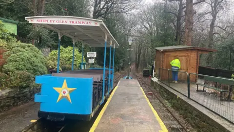 A view downhill of rail tracks with a blue-coloured 