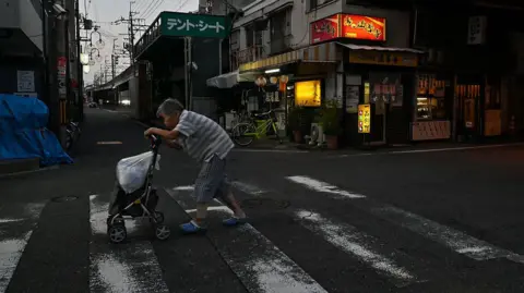 An elderly woman crossing a street