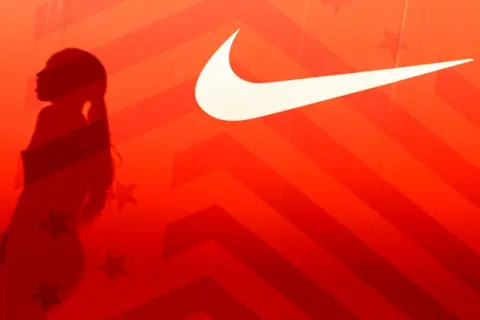 Getty Images A red background with the shadow of Allyson Felix is seen next to a Nike logo