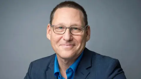 close-up of Avi Lewis' face, smiling