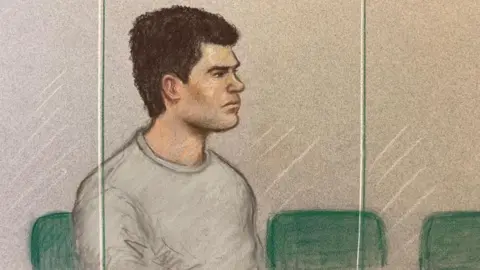 A court artist drew the defendant sitting in the dock wearing a grey tracksuit when he appeared in court earlier on in the trial

