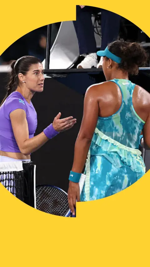 Naomi Osaka standing in front of Sarona Cirstea, who has her hand held out.