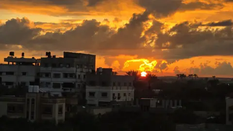 Sunset over a row of buildings