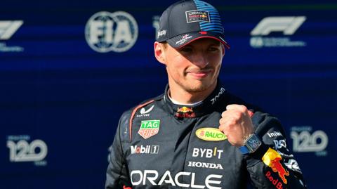Max Verstappen clenches his fist to celebrate taking pole position at Imola