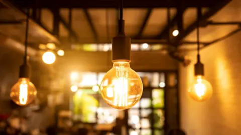 Designer light bulbs glow softly inside a sparsely decorated room.