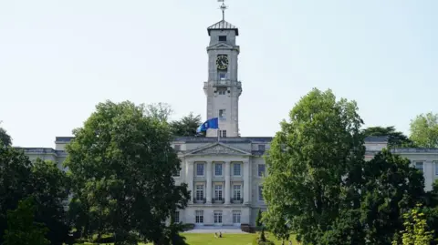A front view of the Trent Building on University Park campus, from across the Highfields Lake.