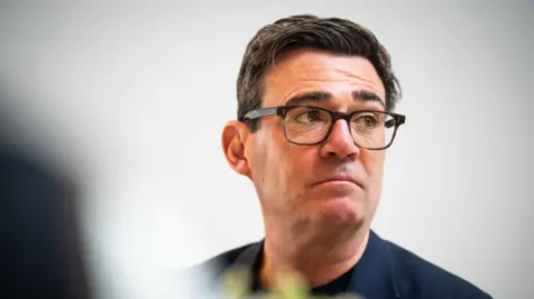 PA Media A picture of Andy Burnham
He is wearing a navy suit jacket.