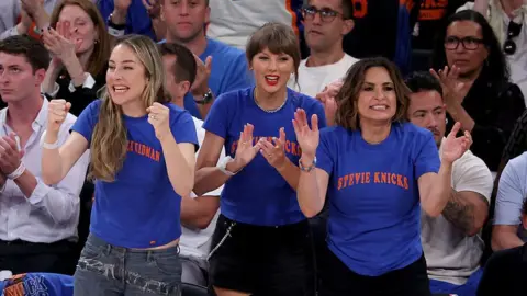 Getty Images (L to R) Este Haim, Taylor Swift, and Mariska Hargitay attend Game Four of the 2026 NBA Finals between the San Antonio Spurs and the New York Knicks at Madison Square Garden on June 10, 2026 in New York City. 