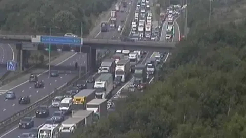 Lots of cars and lorries in a jam on a motorway