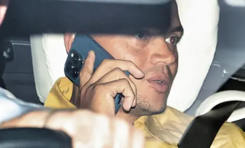 BBC Jermaine Jenas speaks on the phone while in a car driving after leaving talkSport on 23 August