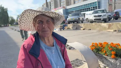 Lady lasting  by roadworthy  with flowers