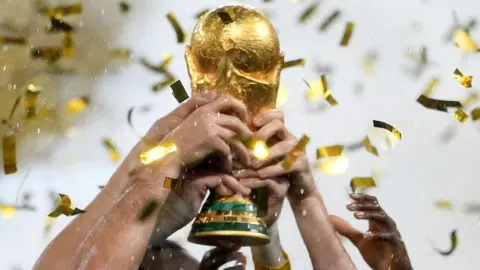 Getty Images players lift the Fifa World Cup trophy