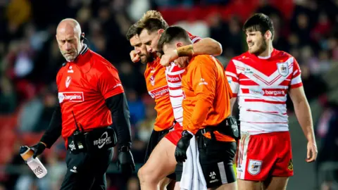Jacob Host is helped from the field during St Helens' win over Bradford