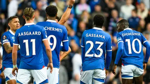 Rangers players watch on as Mohamed Diomande is shown a red card during their Europa League defeat by Genk