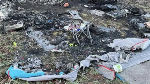 HexhamTV Scorched ground with remnants of burned tents