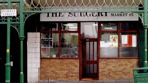 PA/Greater Manchester Police Exterior of doctors surgery called The Surgery on Market Street, Hyde, showing the front door open