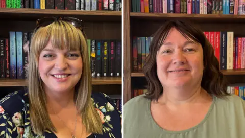 BBC/Eve Connor Ellie White and Carrie McGovern. Ellie has blonde hair that is medium length with a fringe. She is wearing a floral dress that is navy with pink peonies and roses, and she has a pair of tortoiseshell sunglasses on the top of her head. Behind her is a bookcase, and three shelves are visible. Each is full with an array of books in different colours and genres. Carrie is wearing a sage green dress. She has shoulder, length brown hair that is curled, with side bangs. Behind her is a bookcase, and three shelves are visible. Each is full with an array of books in different colours and genres.