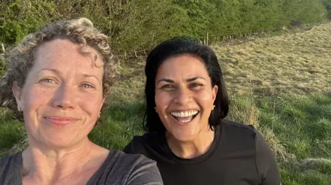 Lucy Pollock walking in the countryside near Barton-in-Fabis with her friend, taking a selfie together.