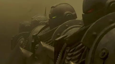 Prime Video Computer generated image shows a line of four heavily armoured troopers staring at an unseen foe. Their gunmetal grey suits of armour are metallic and industrial looking, with bolts and rivets visible. The group is hard to distinguish from the dark grey dust swirling around them.