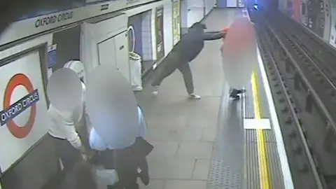 A still from CCTV footage of the moment Tadeusz Potoczek was pushed off the platform at Oxford Circus