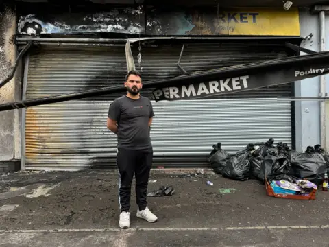 Pacemaker Supermarket owner, Abdelkader, at his premises on the Donegall Road area of Belfast