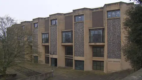 The outside of Winchester Crown Court on a cloudy grey day. 