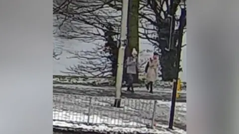 Police Scotland Very grainy CCTV footage of the two sisters in jackets on a bridge