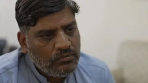 Nasir Mehmood, wearing a light blue shirt