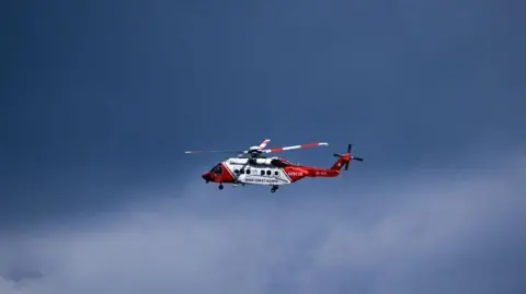 Getty Images A red and white helicopter in flight